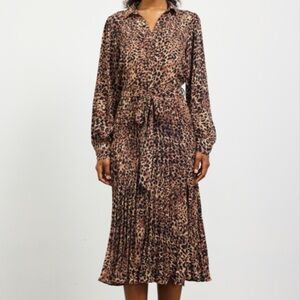 New with tags. Leopard dress w pleated skirt and belt. Skies are Blue